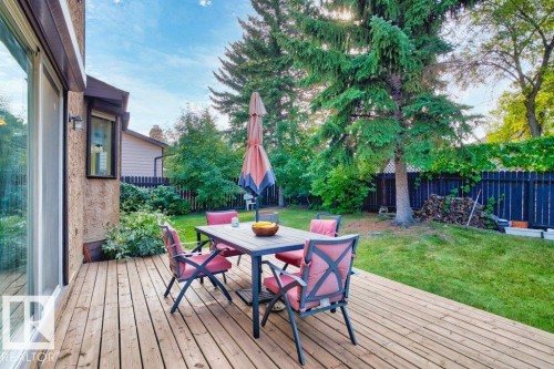 Wooden terrace with outdoor dining area and a fenced backyard - 10429 28A Avenue, Edmonton, AB - Outdoor With Deck Patio Veranda