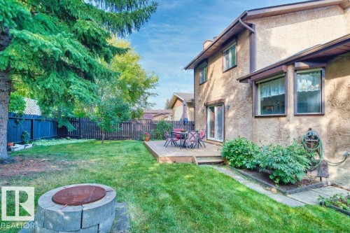 Fenced backyard featuring a deck and an outdoor fire pit - 10429 28A Avenue, Edmonton, AB - Outdoor