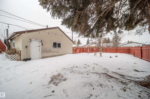 Snow covered property with a fenced backyard and stucco siding - 8908 130 Avenue Nw, Edmonton, AB - Outdoor