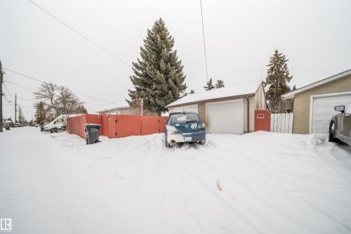 Yard covered in snow with an outbuilding and a detached garage - 8908 130 Avenue Nw, Edmonton, AB - Outdoor