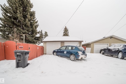 Snow covered garage featuring a garage - 8908 130 Avenue Nw, Edmonton, AB - Outdoor