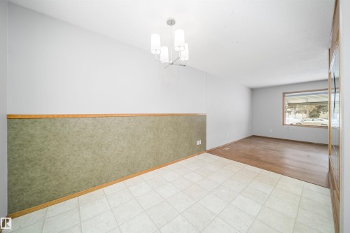 Unfurnished room with hanging lights and baseboards - 8908 130 Avenue Nw, Edmonton, AB - Indoor Photo Showing Other Room
