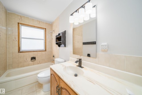 Bathroom with vanity, shower / tub combination, and light tile patterned floors - 8908 130 Avenue Nw, Edmonton, AB - Indoor Photo Showing Bathroom