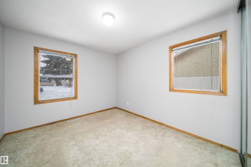 Empty room featuring light colored carpet and baseboards - 8908 130 Avenue Nw, Edmonton, AB - Indoor Photo Showing Other Room