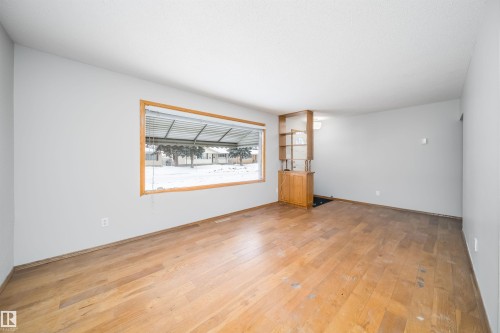 Spare room featuring light wood-type flooring - 8908 130 Avenue Nw, Edmonton, AB - Indoor Photo Showing Other Room