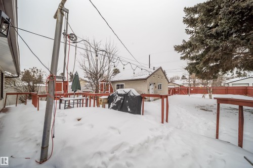 Yard covered in snow featuring a wooden deck - 8908 130 Avenue Nw, Edmonton, AB - Outdoor