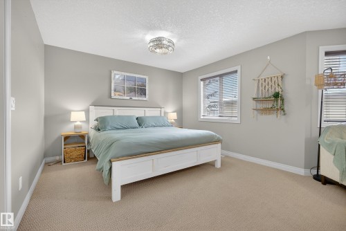 Bedroom with light carpet and a textured ceiling - 44 903 Rutherford Road, Edmonton, AB - Indoor Photo Showing Bedroom