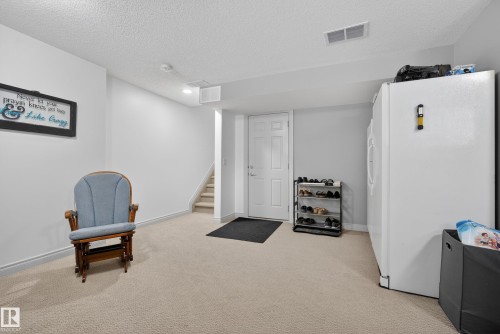 Sitting room featuring light colored carpet, a textured ceiling, and recessed lighting - 44 903 Rutherford Road, Edmonton, AB - Indoor