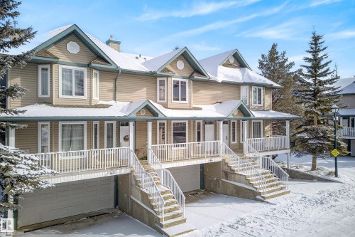 View of front of property with a porch, an attached garage, and a chimney - 44 903 Rutherford Road, Edmonton, AB - Outdoor With Deck Patio Veranda With Facade