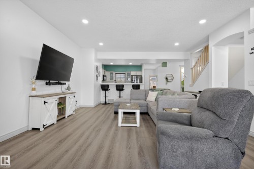 Living room with light wood-style flooring, recessed lighting, and a textured ceiling - 44 903 Rutherford Road, Edmonton, AB - Indoor Photo Showing Living Room