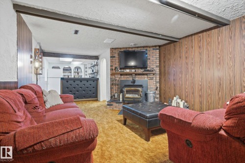 6903 12 Avenue, Edmonton, AB - Indoor Photo Showing Living Room With Fireplace