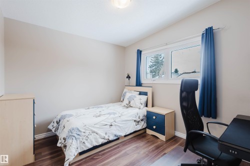 Bedroom featuring wood finished floors, vaulted ceiling, and a desk - 11519 37A Avenue, Edmonton, AB - Indoor Photo Showing Bedroom