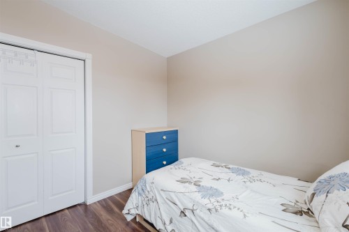 Bedroom featuring a closet and dark wood-type flooring - 11519 37A Avenue, Edmonton, AB - Indoor Photo Showing Bedroom
