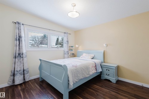 Bedroom featuring dark wood finished floors and lofted ceiling - 11519 37A Avenue, Edmonton, AB - Indoor Photo Showing Bedroom