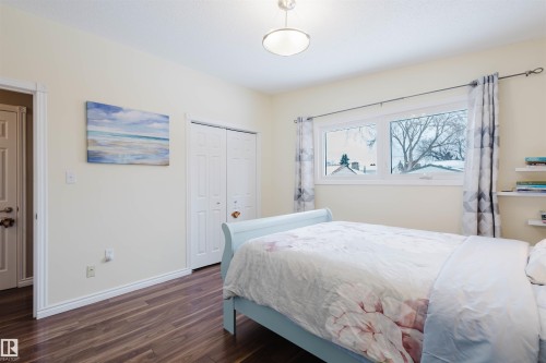 Bedroom with dark wood-style flooring and a closet - 11519 37A Avenue, Edmonton, AB - Indoor Photo Showing Bedroom