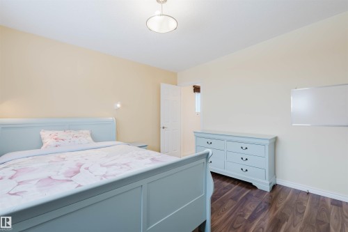 Bedroom with dark wood finished floors and baseboards - 11519 37A Avenue, Edmonton, AB - Indoor Photo Showing Bedroom