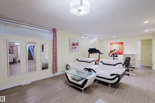 Workout room with a textured ceiling and wood finished floors - 11519 37A Avenue, Edmonton, AB - Indoor