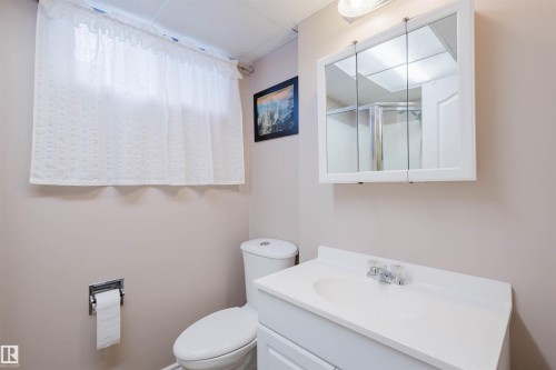Full bath featuring vanity and a shower with shower door - 11519 37A Avenue, Edmonton, AB - Indoor Photo Showing Bathroom