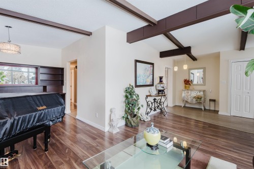 Living area with dark wood-type flooring and beamed ceiling - 11519 37A Avenue, Edmonton, AB - Indoor