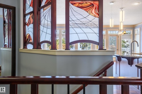 Stairs featuring a textured ceiling and suspended lighting - 48 Fairway Point(E), Spruce Grove, AB - Indoor Photo Showing Other Room