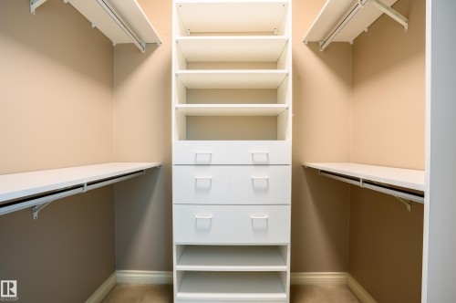 Walk in closet featuring light colored carpet - 48 Fairway Point(E), Spruce Grove, AB - Indoor With Storage