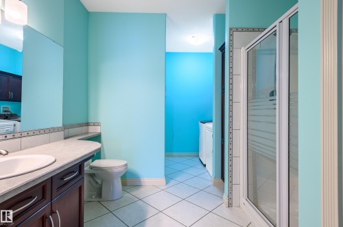 Full bath featuring vanity, a shower stall, and light tile patterned flooring - 48 Fairway Point(E), Spruce Grove, AB - Indoor Photo Showing Bathroom