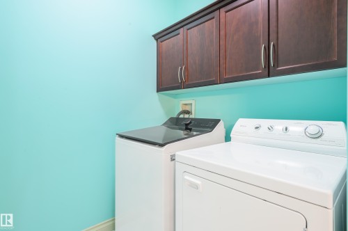 Laundry area with independent washer and dryer and cabinet space - 48 Fairway Point(E), Spruce Grove, AB - Indoor Photo Showing Laundry Room