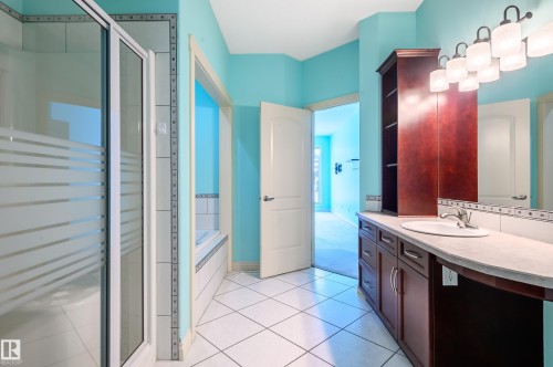 Bathroom featuring vanity, a garden tub, a shower stall, and light tile patterned floors - 48 Fairway Point(E), Spruce Grove, AB - Indoor Photo Showing Bathroom