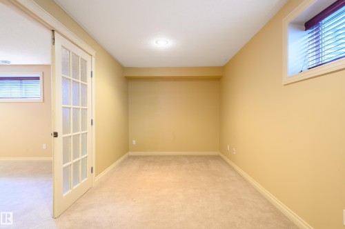 Unfurnished room with light colored carpet and baseboards - 48 Fairway Point(E), Spruce Grove, AB - Indoor Photo Showing Other Room
