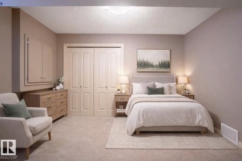 Bedroom featuring light colored carpet, a closet, and a textured ceiling stage photo - 48 Fairway Point(E), Spruce Grove, AB - Indoor Photo Showing Bedroom