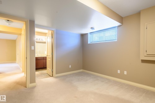 Unfurnished bedroom featuring light carpet and ensuite bath - 48 Fairway Point(E), Spruce Grove, AB - Indoor Photo Showing Other Room