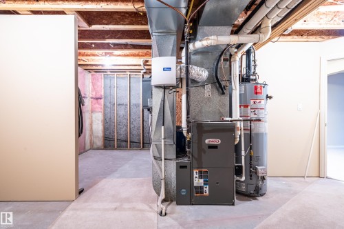 Utility room with gas water heater and heating unit - 48 Fairway Point(E), Spruce Grove, AB - Indoor Photo Showing Basement