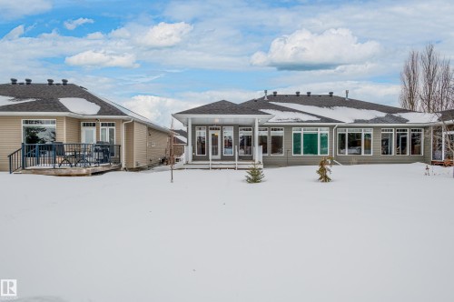 Snow covered property featuring a deck - 48 Fairway Point(E), Spruce Grove, AB - Outdoor
