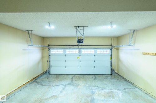 Garage with a garage door opener - 48 Fairway Point(E), Spruce Grove, AB - Indoor Photo Showing Garage