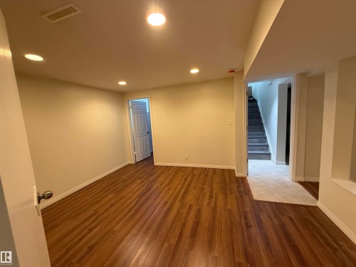 Unfurnished room with dark wood-style floors and recessed lighting - 13323 68 Street, Edmonton, AB - Indoor Photo Showing Other Room