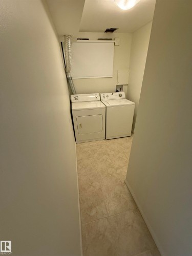 Laundry room featuring separate washer and dryer - 13323 68 Street, Edmonton, AB - Indoor Photo Showing Laundry Room
