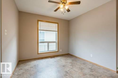 Spare room with stone finish floors and a ceiling fan - 4827 54 Avenue, Wetaskiwin, AB - Indoor Photo Showing Other Room