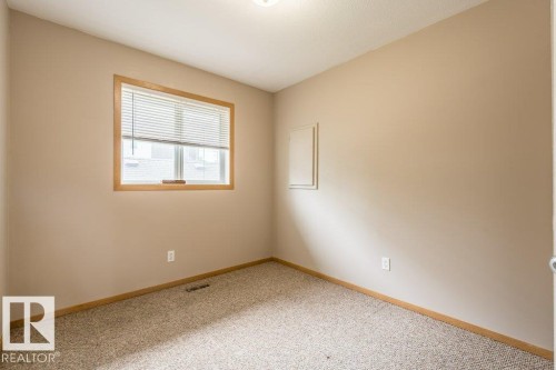 Empty room with baseboards and light colored carpet - 4827 54 Avenue, Wetaskiwin, AB - Indoor Photo Showing Other Room