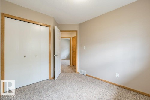 Unfurnished bedroom featuring a closet and light colored carpet - 4827 54 Avenue, Wetaskiwin, AB - Indoor Photo Showing Other Room