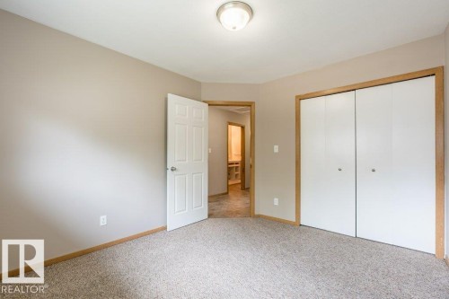 Unfurnished bedroom featuring a closet and light colored carpet - 4827 54 Avenue, Wetaskiwin, AB - Indoor Photo Showing Other Room