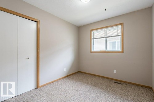Unfurnished bedroom featuring a closet and light colored carpet - 4827 54 Avenue, Wetaskiwin, AB - Indoor Photo Showing Other Room