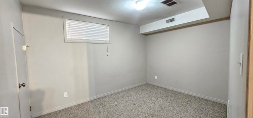 Spare room with baseboards and a textured ceiling - 4827 54 Avenue, Wetaskiwin, AB - Indoor Photo Showing Other Room