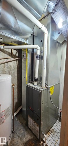 Utilities featuring water heater and heating unit - 4827 54 Avenue, Wetaskiwin, AB - Indoor Photo Showing Basement