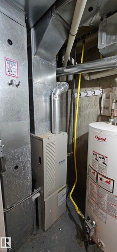 Utilities with water heater and heating unit - 4827 54 Avenue, Wetaskiwin, AB - Indoor Photo Showing Basement