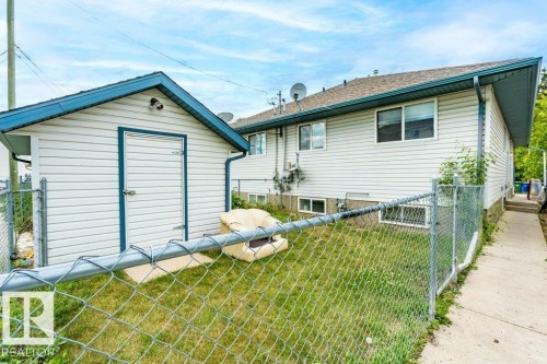 Rear view of property featuring a storage unit and a gate - 4827 54 Avenue, Wetaskiwin, AB - Outdoor With Exterior