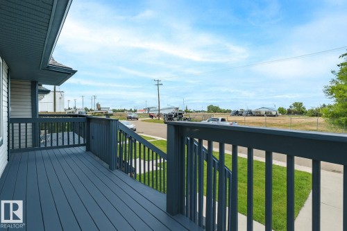 Deck featuring a yard and a residential view - 4827 54 Avenue, Wetaskiwin, AB - Outdoor