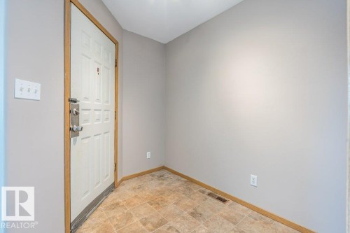 Entryway featuring baseboards and stone finish floors - 4827 54 Avenue, Wetaskiwin, AB - Indoor Photo Showing Other Room