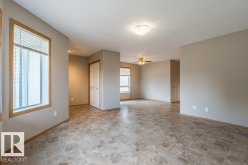Unfurnished room with ceiling fan and stone finish flooring - 4827 54 Avenue, Wetaskiwin, AB - Indoor Photo Showing Other Room