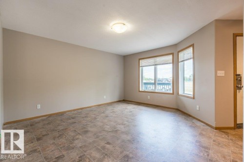 Spare room with stone finish floors - 4827 54 Avenue, Wetaskiwin, AB - Indoor Photo Showing Other Room