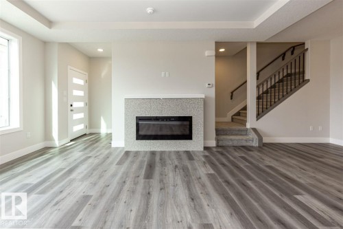 201 Caledonia Drive, Leduc, AB - Indoor Photo Showing Living Room With Fireplace